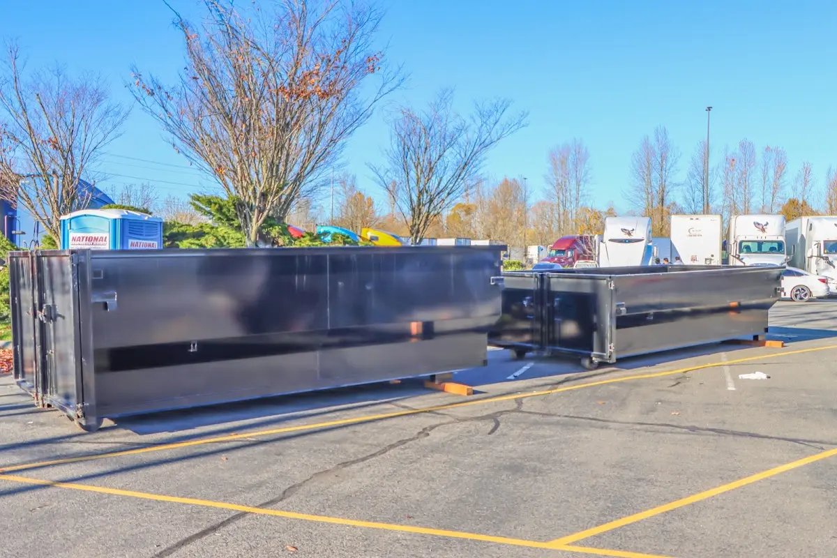 Professional dumpster rental service with roll-off container on residential driveway in Headland